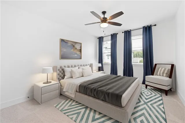 a bedroom with a large bed and a chandelier