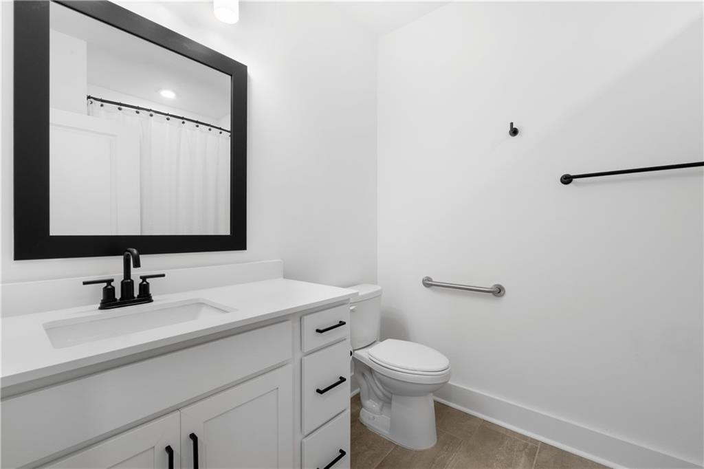 3321 Orwell Way, Unit 3301 Cumming, GA 30041 - Photo 28 of 43 a bathroom with a toilet sink and mirror
