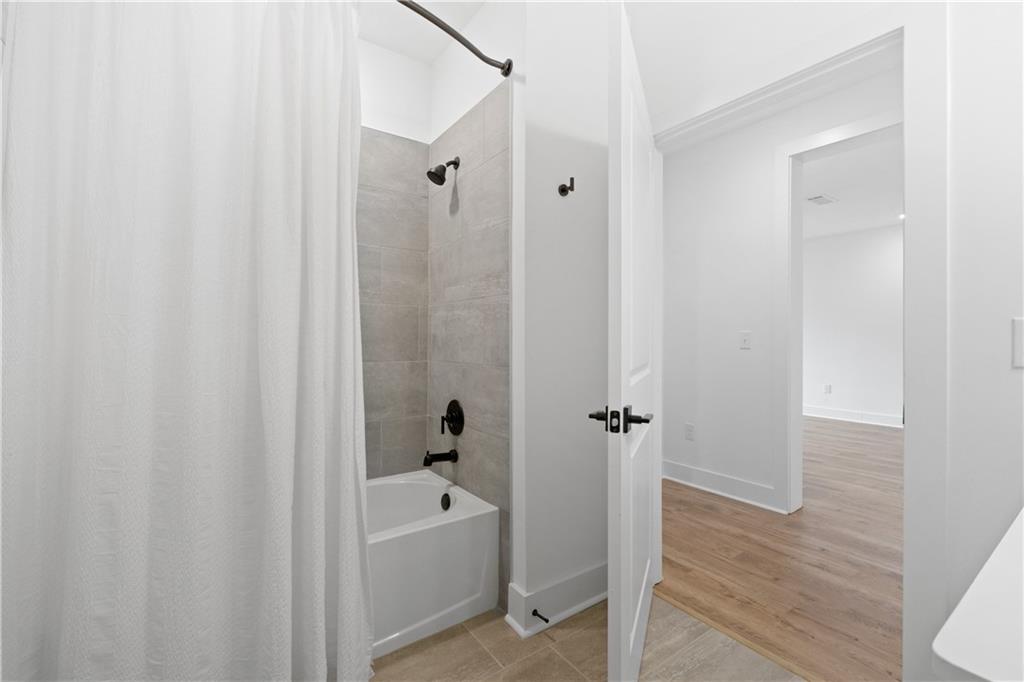 3321 Orwell Way, Unit 3301 Cumming, GA 30041 - Photo 29 of 43 a bathroom with a bathtub a toilet and a shower