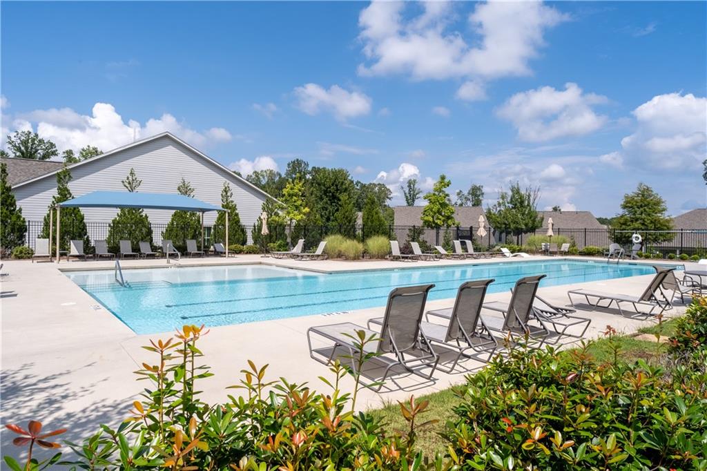 3321 Orwell Way, Unit 3301 Cumming, GA 30041 - Photo 34 of 43 a view of a swimming pool with lawn chairs and plants