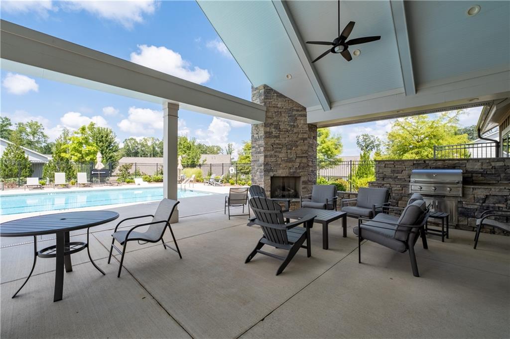 3321 Orwell Way, Unit 3301 Cumming, GA 30041 - Photo 35 of 43 a view of a porch with furniture and a yard