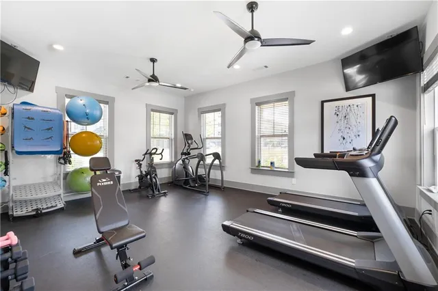 a room with gym equipment and a flat tv screen