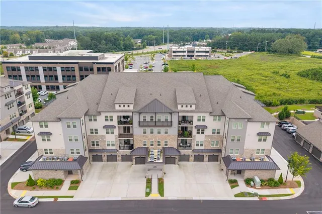 an aerial view of multiple houses with a yard