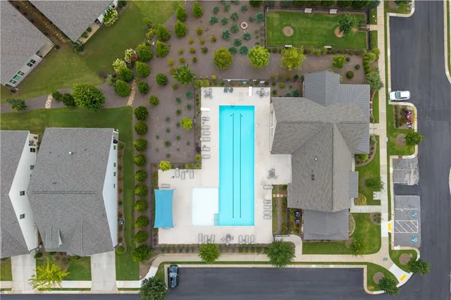 aerial view of a house with a yard and large tree