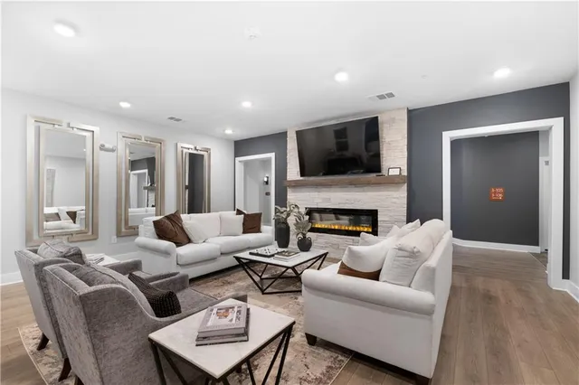 a living room with furniture a fireplace and a flat screen tv