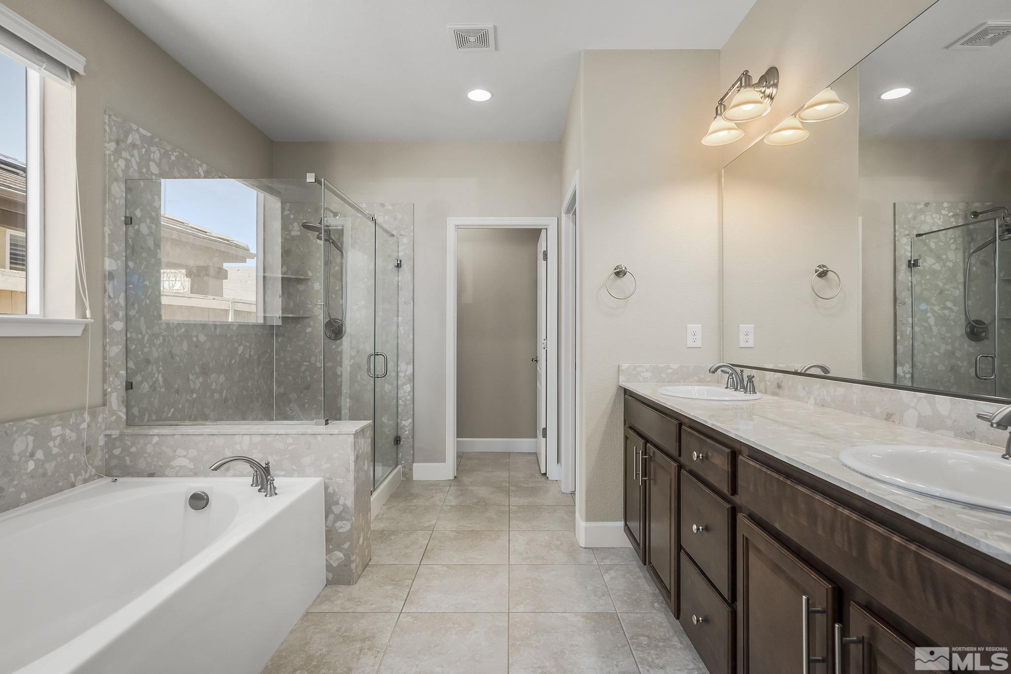 10320 Culiacan Pass Trail Reno, NV 89521 - Photo 18 of 33 a spacious bathroom with a tub sink shower and mirror