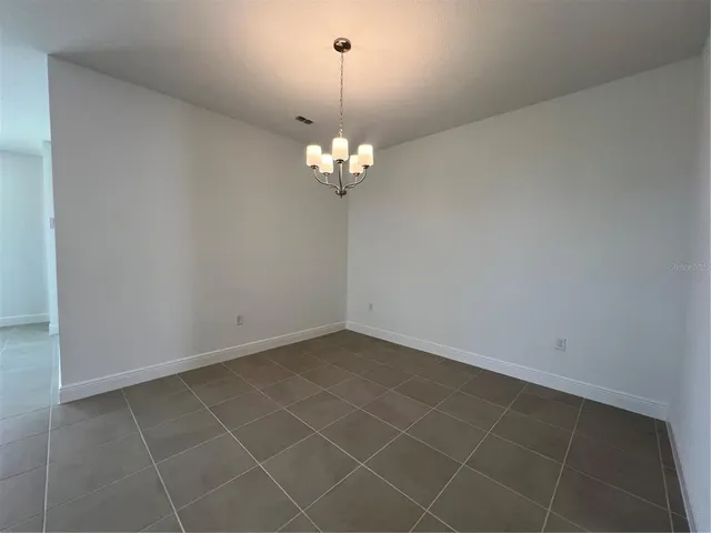 a view of a chandelier fan and entryway