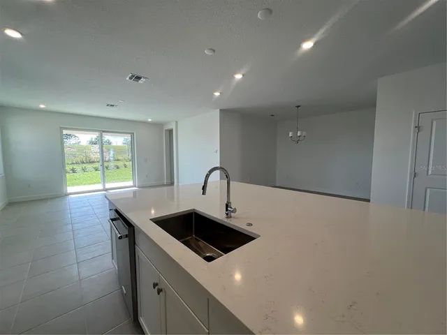 a kitchen with a sink and a stove top oven