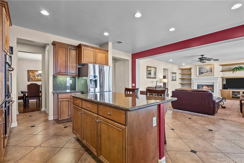 19654 Mathilde Lane Saugus, CA 91350 - Photo 11 of 38 a kitchen with stainless steel appliances kitchen island granite countertop a sink and cabinets
