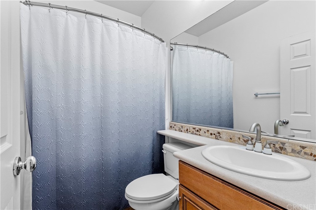 19654 Mathilde Lane Saugus, CA 91350 - Photo 17 of 38 a bathroom with a sink a toilet and a mirror