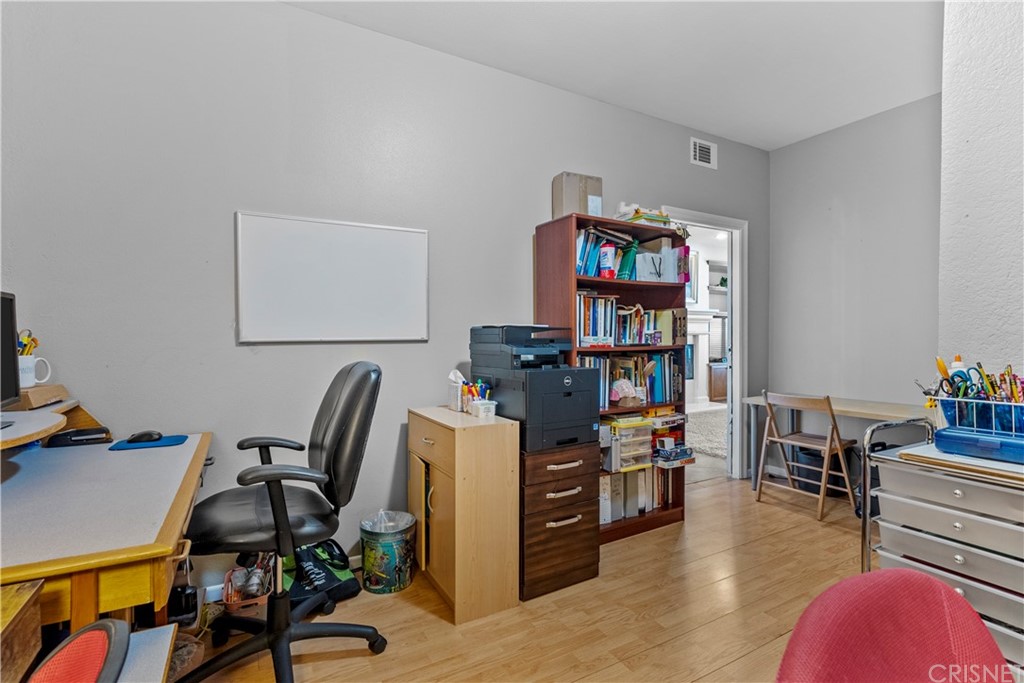 19654 Mathilde Lane Saugus, CA 91350 - Photo 19 of 38 a view of a workspace with furniture and book shelf