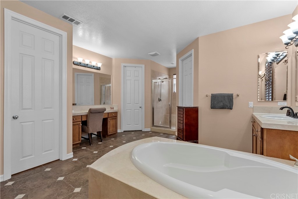 19654 Mathilde Lane Saugus, CA 91350 - Photo 29 of 38 a spacious bathroom with a bathtub and a sink