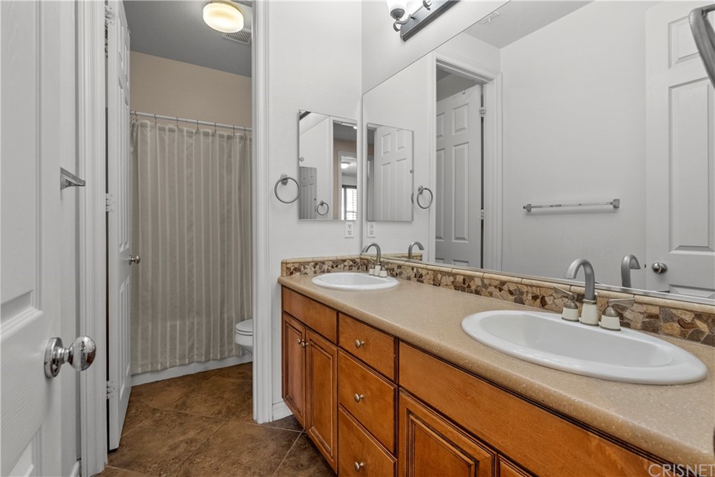 19654 Mathilde Lane Saugus, CA 91350 - Photo 34 of 38 a bathroom with a sink double vanity and a mirror