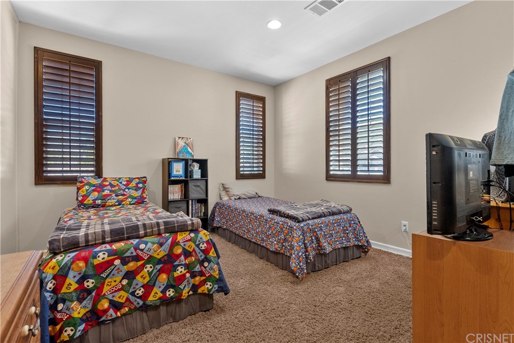19654 Mathilde Lane Saugus, CA 91350 - Photo 36 of 38 a bedroom with two beds and a dresser