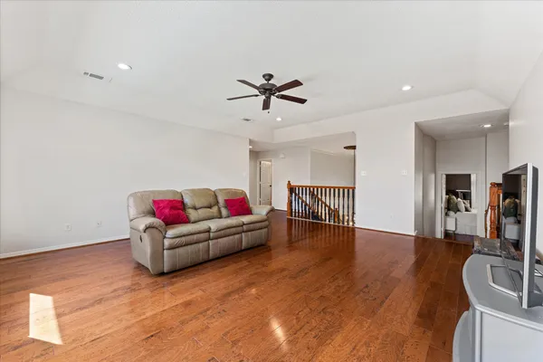 a living room with furniture and wooden floor