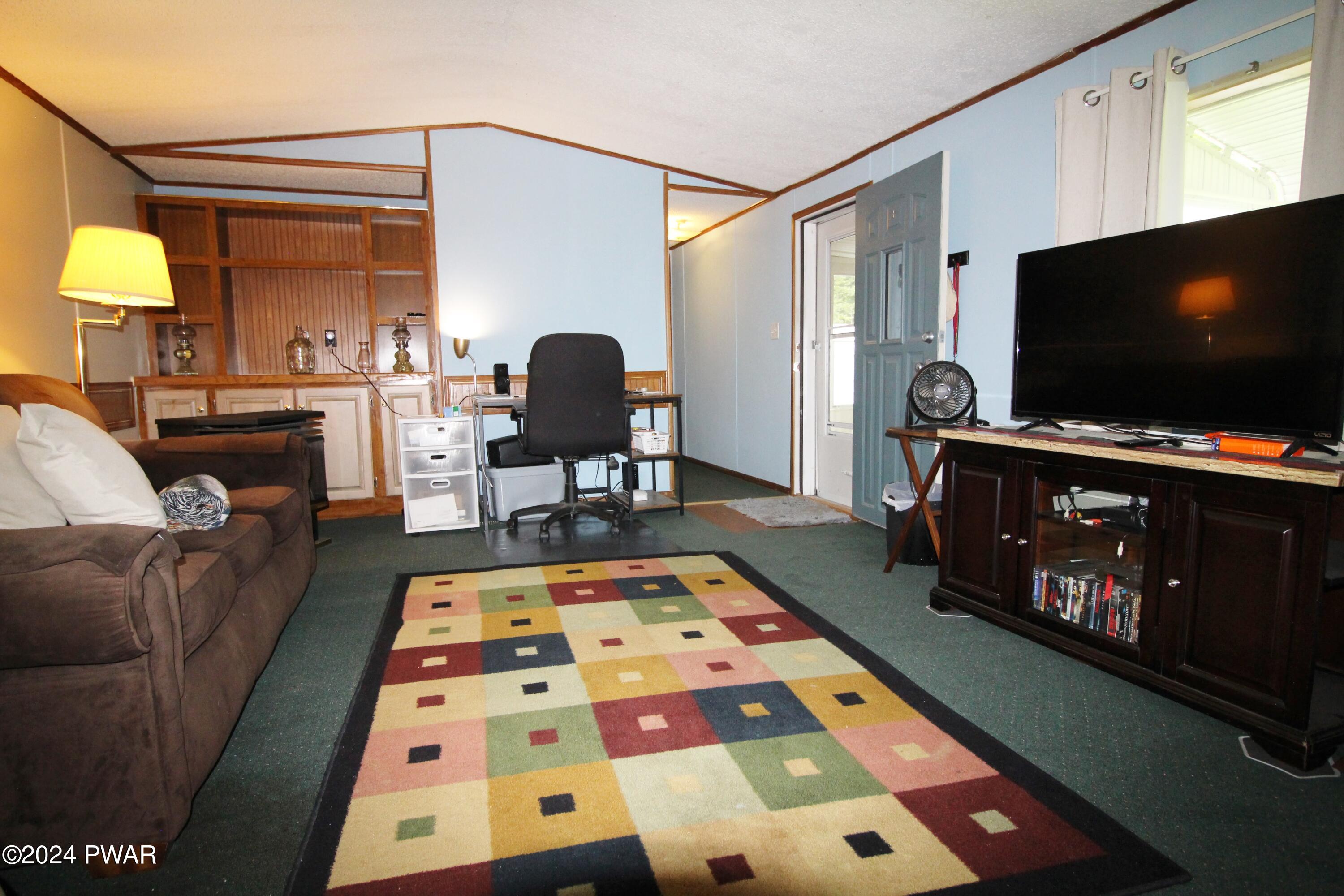 10 Madison Estate Moscow, PA 18444 - Photo 12 of 45 a living room with furniture and a flat screen tv