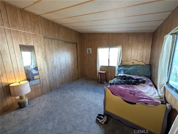 a bed room with a bed and a chair