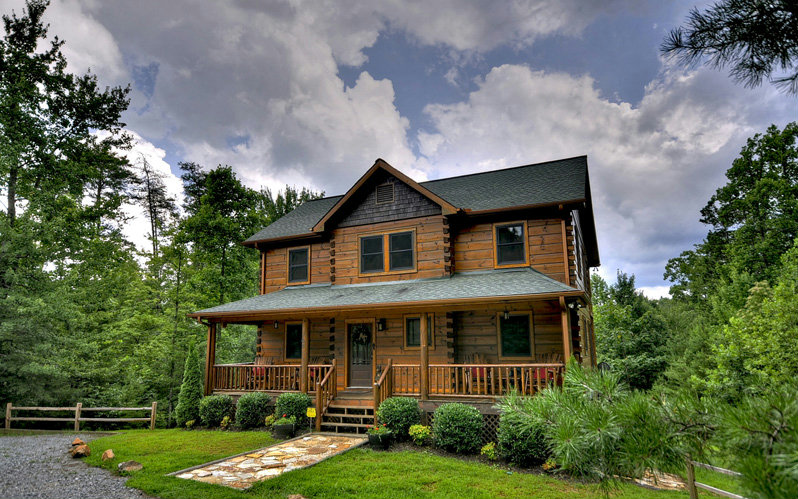 63 Deer Hunter Road Blue Ridge, GA 30513 - Photo 1 of 1 a front view of a house with garden