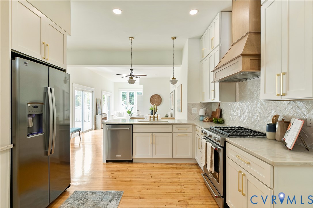 2402 Riverside Drive Richmond, VA 23225 - Photo 17 of 50 a kitchen with stainless steel appliances granite countertop a refrigerator a sink and white cabinets