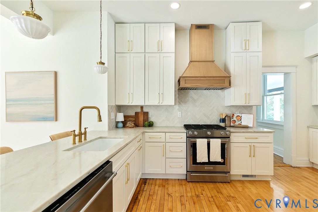 2402 Riverside Drive Richmond, VA 23225 - Photo 18 of 50 a kitchen with stainless steel appliances granite countertop a sink a stove and a refrigerator