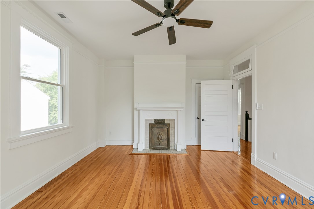 2402 Riverside Drive Richmond, VA 23225 - Photo 33 of 50 an empty room with wooden floor a ceiling fan and windows