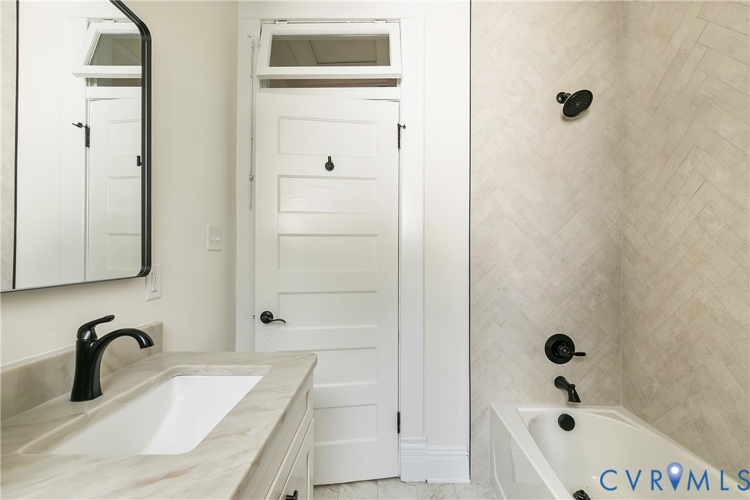 2402 Riverside Drive Richmond, VA 23225 - Photo 36 of 50 a bathroom with a tub sink and mirror