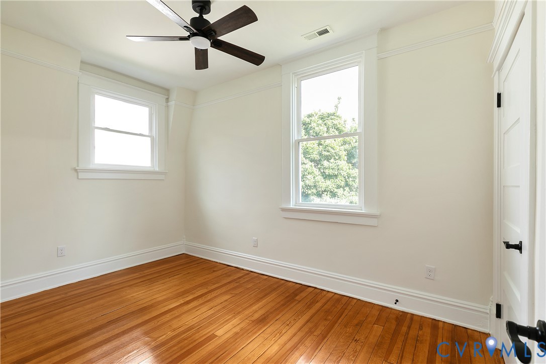 2402 Riverside Drive Richmond, VA 23225 - Photo 37 of 50 a view of empty room with wooden floor and fan