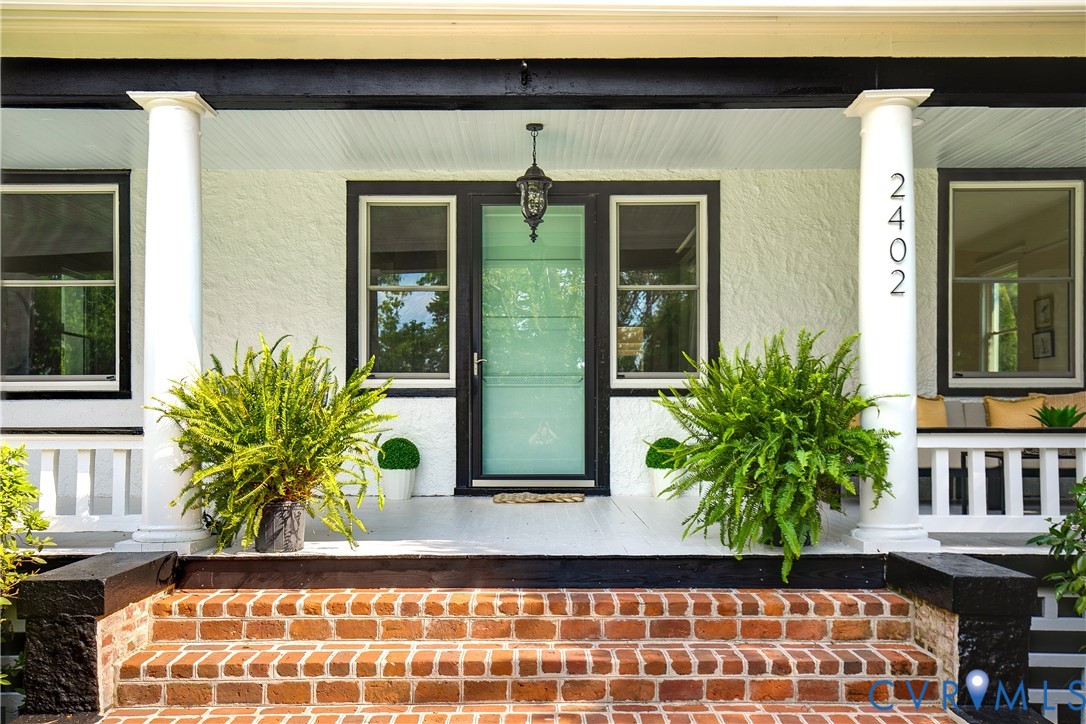 2402 Riverside Drive Richmond, VA 23225 - Photo 4 of 50 a potted plant sitting in front of a house