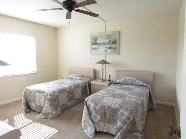 a bedroom with two beds and painting on the wall