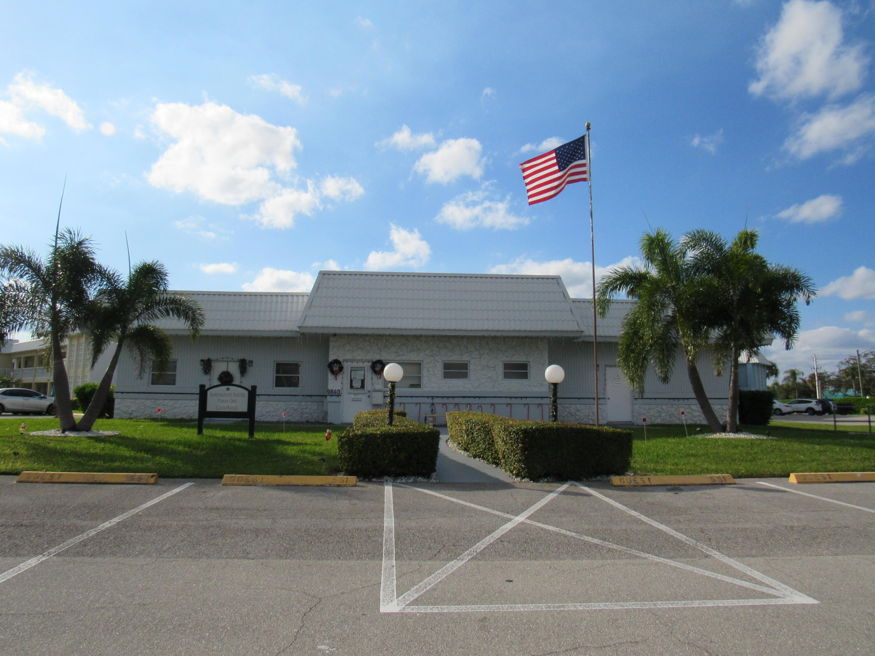 9872 Marina Boulevard, Unit 1438 Boca Raton, FL 33428 - Photo 17 of 18 a view of a building with a backyard and a garden