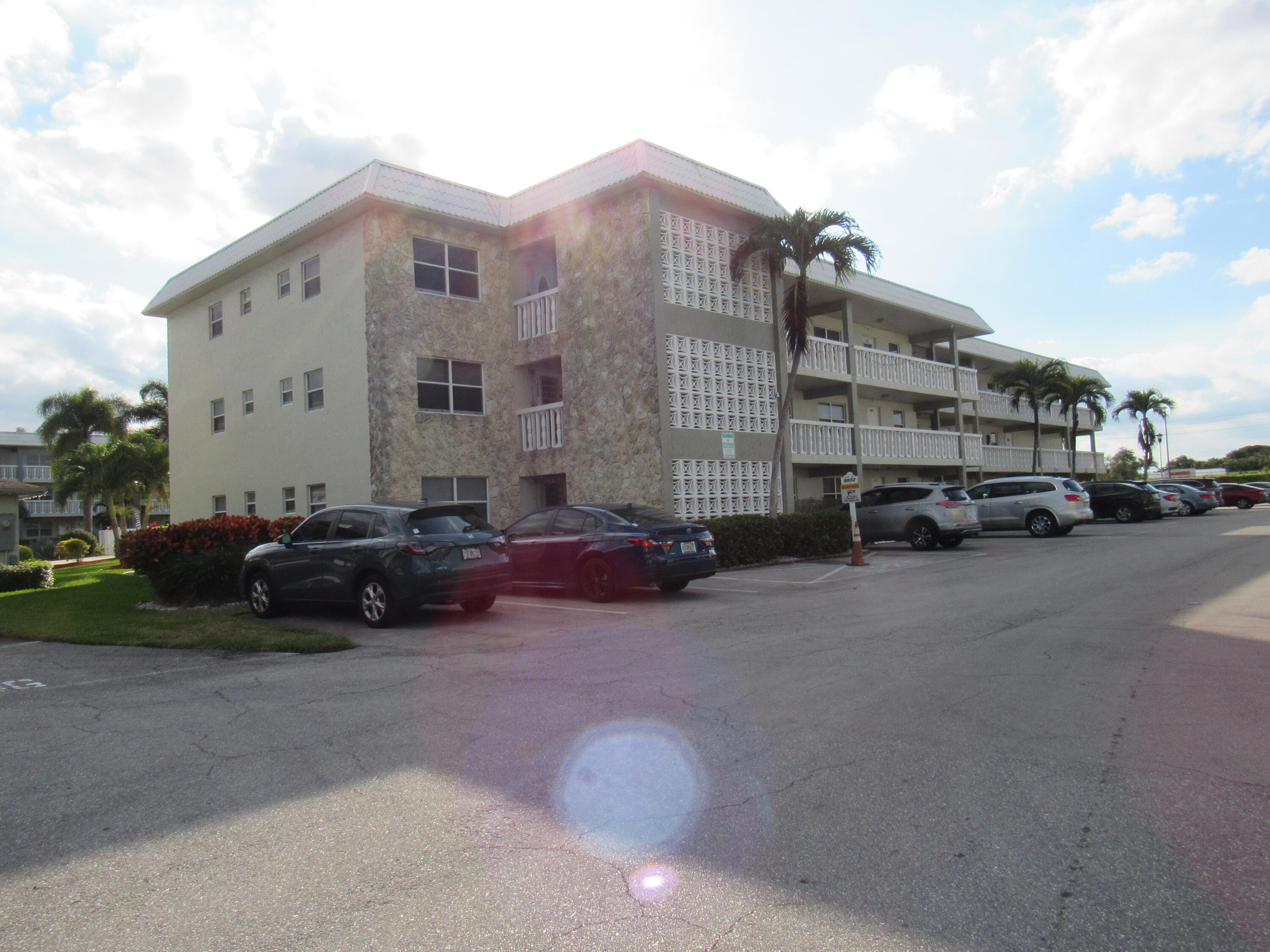 9872 Marina Boulevard, Unit 1438 Boca Raton, FL 33428 - Photo 2 of 18 a car parked in front of a buildings
