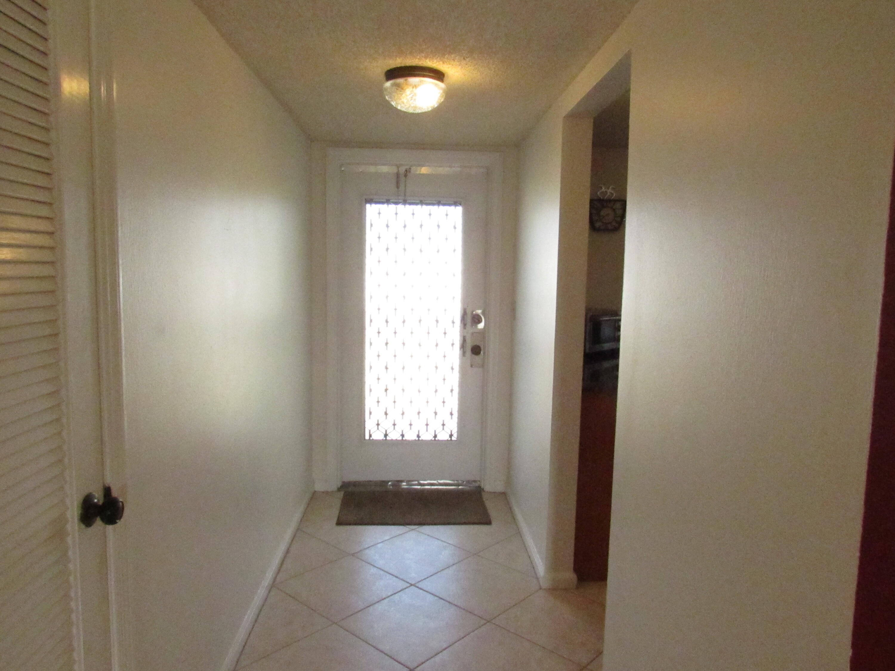 9872 Marina Boulevard, Unit 1438 Boca Raton, FL 33428 - Photo 3 of 18 a view of an empty room and a window