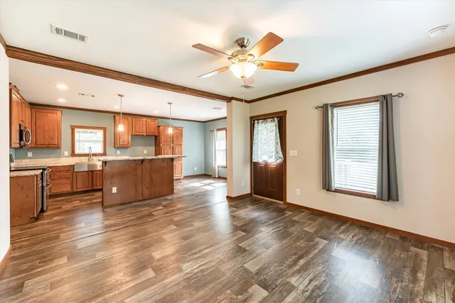 a view of a kitchen with a sink cabinets and wooden floor