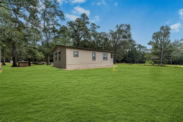 a backyard of a house with lots of green space
