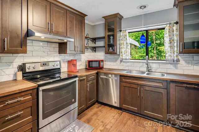 a kitchen with a wooden floor and cabinets