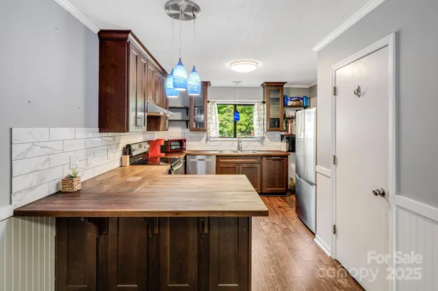 a kitchen with a stove a sink and a refrigerator