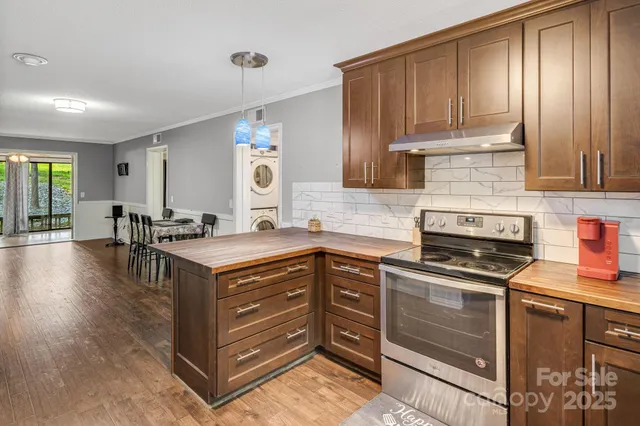 a kitchen with stainless steel appliances granite countertop a stove a sink and a microwave