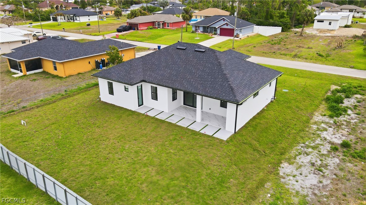 1013 Anson Avenue Lehigh Acres, FL 33971 - Photo 27 of 33 a aerial view of a house with a swimming pool