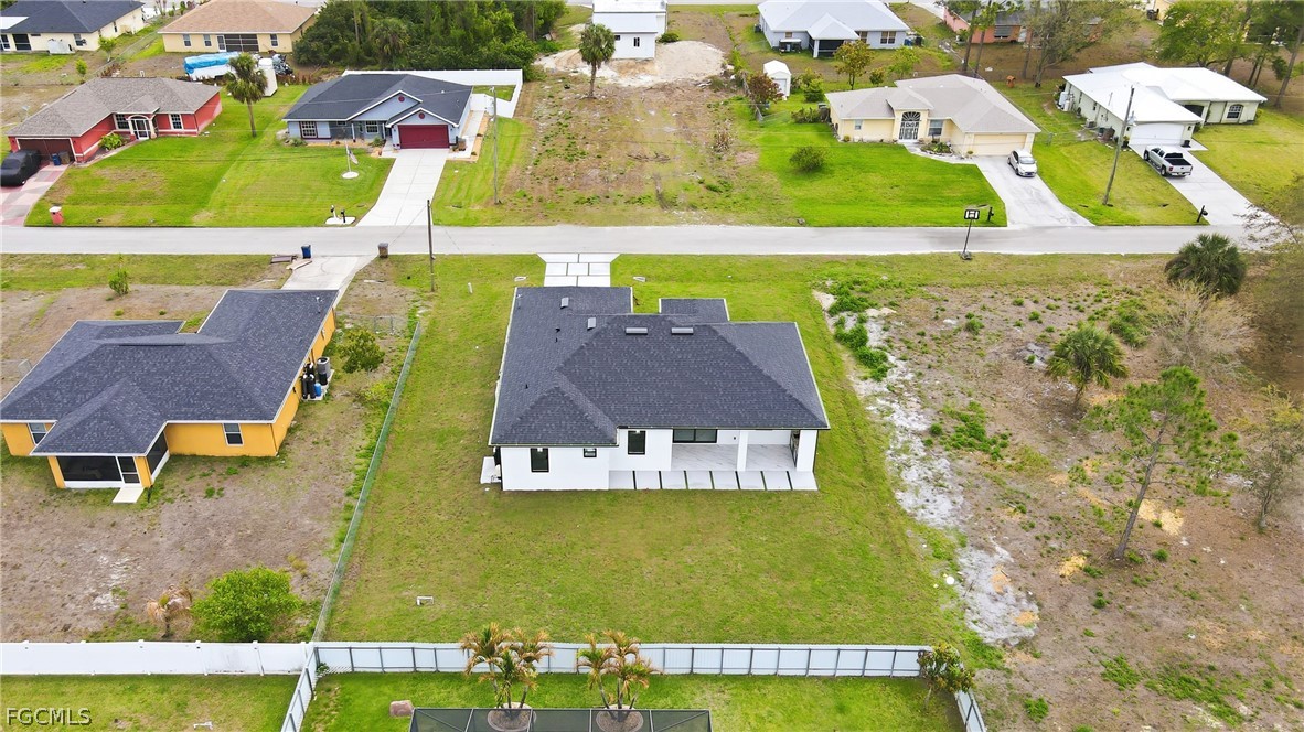 1013 Anson Avenue Lehigh Acres, FL 33971 - Photo 29 of 33 an aerial view of a house with a swimming pool
