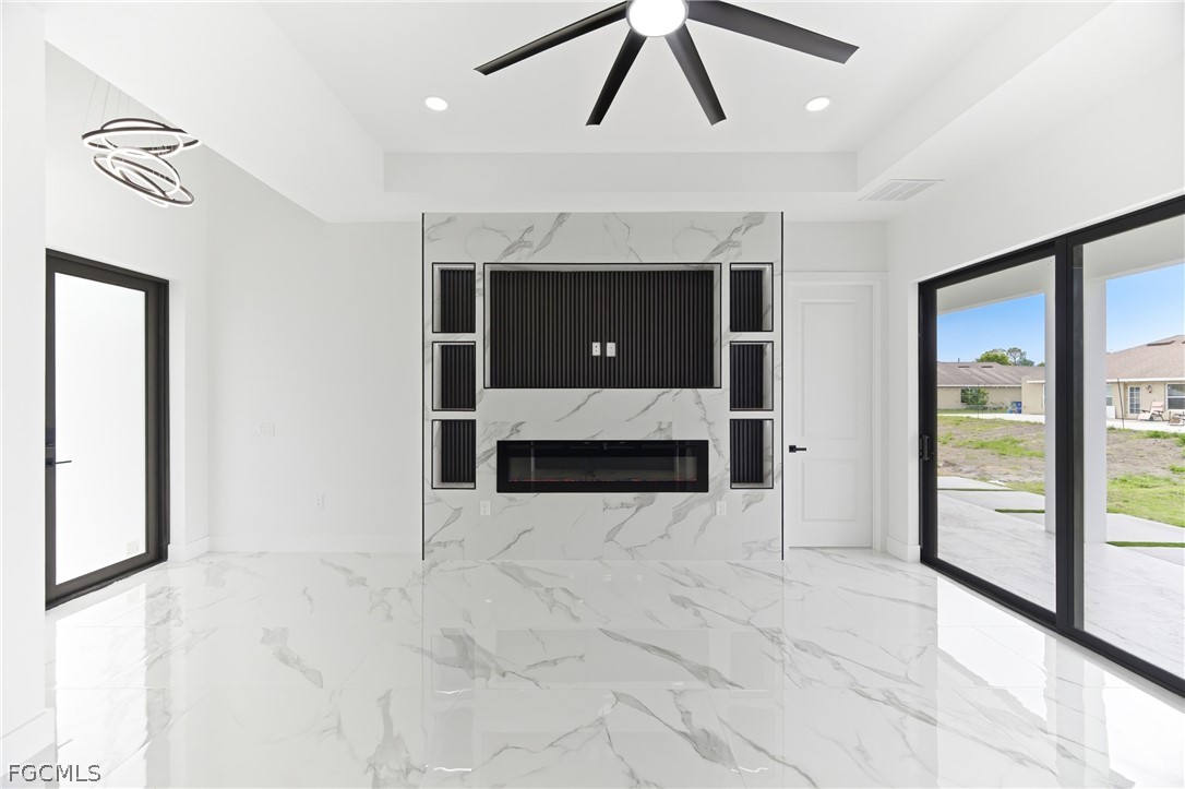 1013 Anson Avenue Lehigh Acres, FL 33971 - Photo 4 of 33 a view of an empty room with a fireplace and a window