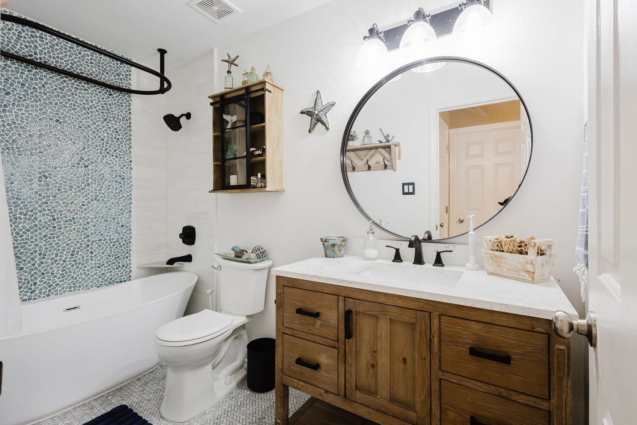 305 Great Falls Road Collierville, TN 38017 - Photo 13 of 23 Modern bathroom featuring a wood-finish vanity with a single basin sink, white countertop, and matte black fixtures