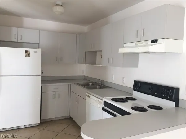 a kitchen with cabinets and appliances