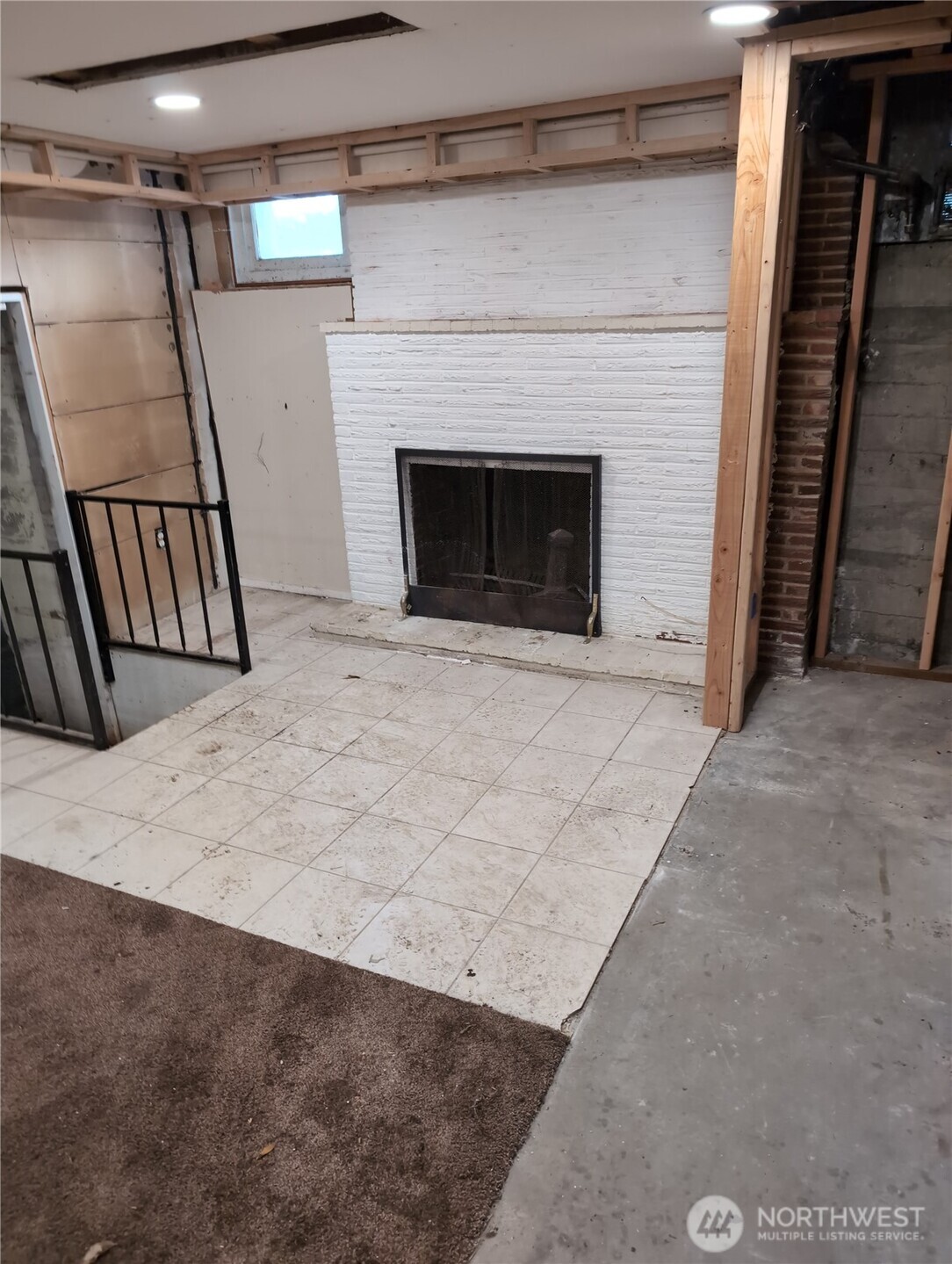6925 52nd Avenue South Seattle, WA 98118 - Photo 9 of 9 a view of an empty room with wooden floor and a fireplace