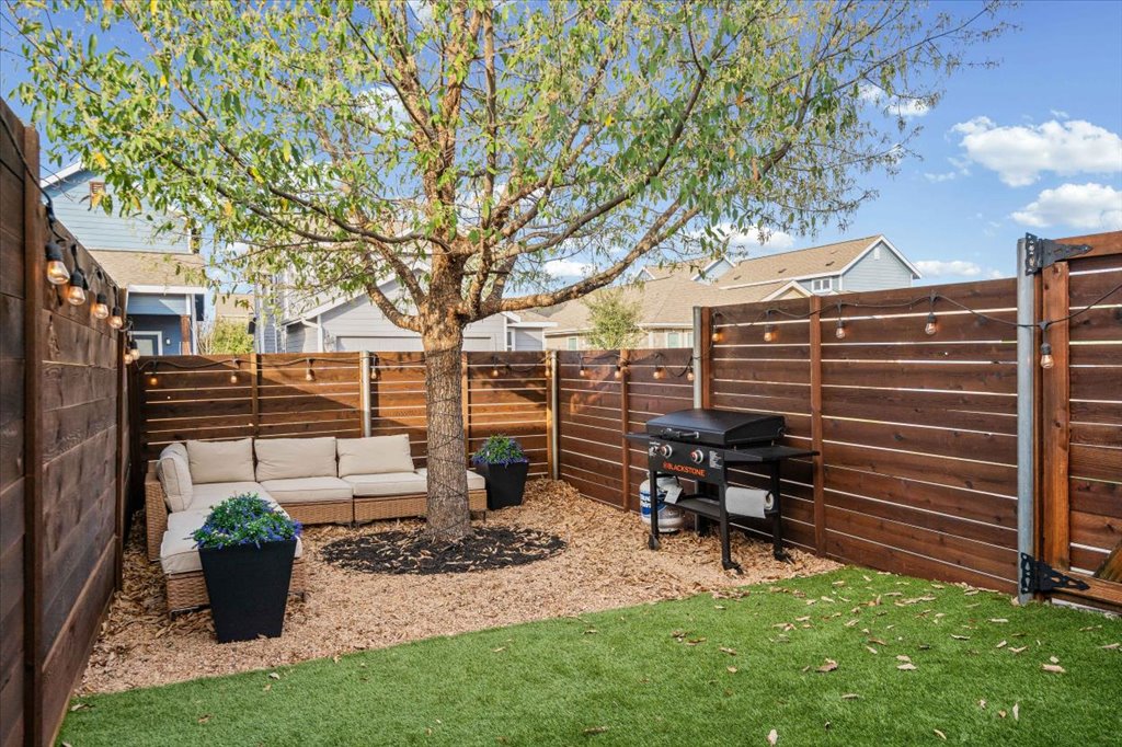 5912 Corrine Lane Austin, TX 78747 - Photo 22 of 27 Fenced backyard with an outdoor lounge area and artificial turf for lower maintenance.