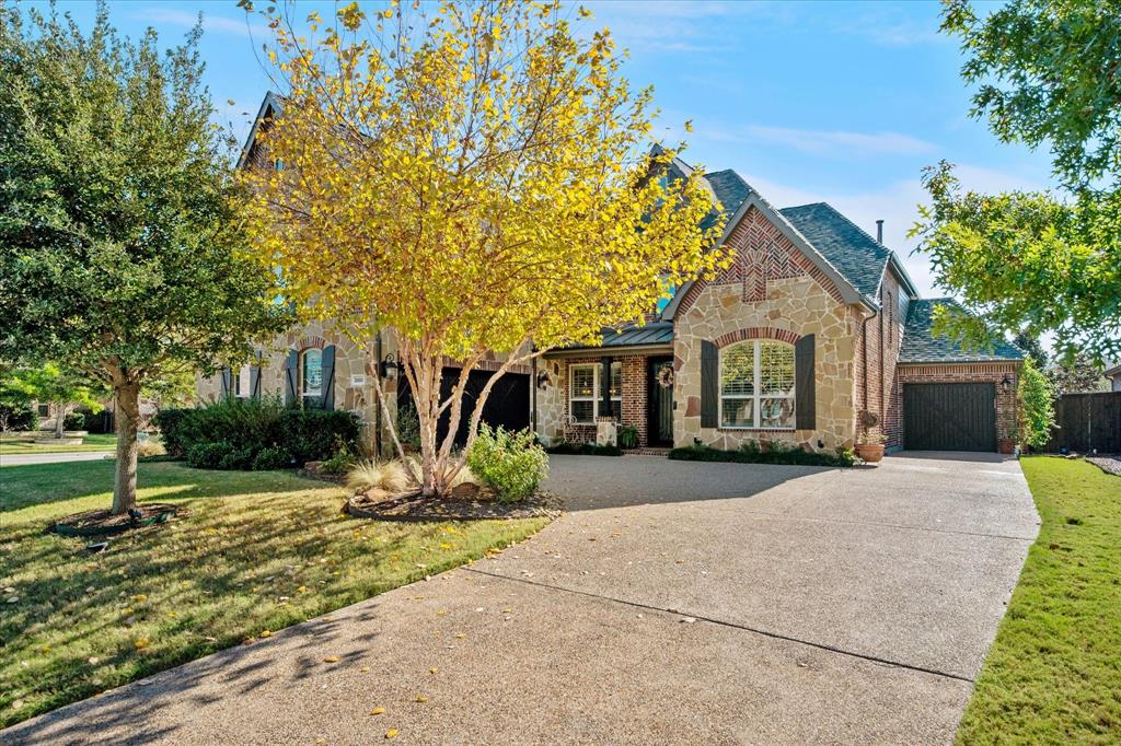 2880 Redfern Drive Trophy Club, TX 76262 - Photo 1 of 40 a front view of a house with garden