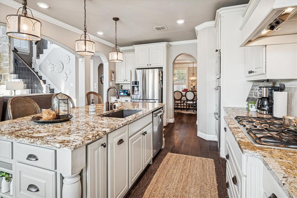 2880 Redfern Drive Trophy Club, TX 76262 - Photo 16 of 40 a kitchen with stainless steel appliances granite countertop a sink stove and refrigerator