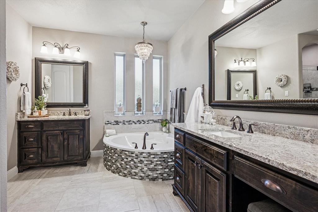 2880 Redfern Drive Trophy Club, TX 76262 - Photo 18 of 40 a bathroom with a granite countertop double vanity sink mirror and bathtub
