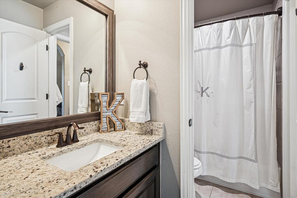 2880 Redfern Drive Trophy Club, TX 76262 - Photo 25 of 40 a bathroom with a granite countertop sink and a mirror