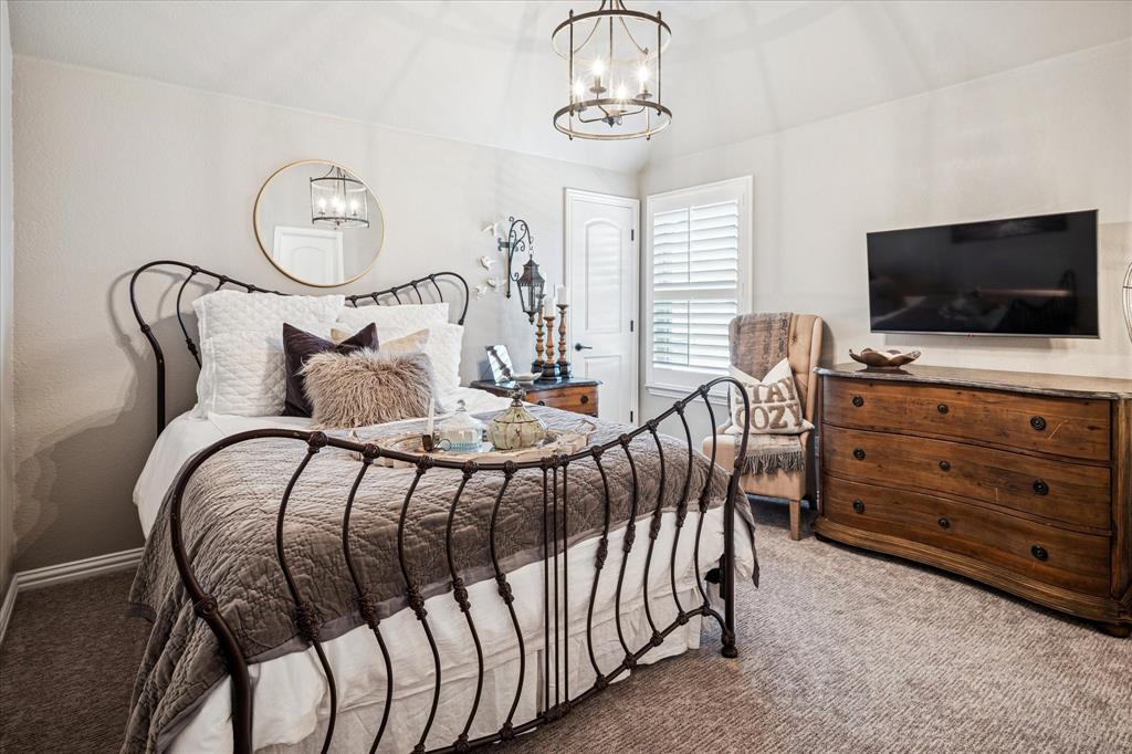 2880 Redfern Drive Trophy Club, TX 76262 - Photo 27 of 40 a bedroom with a bed and a flat screen tv