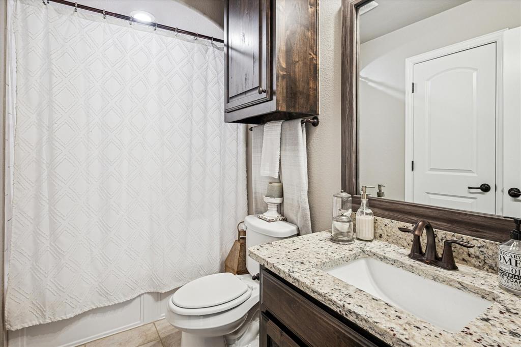 2880 Redfern Drive Trophy Club, TX 76262 - Photo 28 of 40 a bathroom with a granite countertop sink toilet and mirror